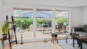 A spacious living room with large sliding glass doors leading to an outdoor patio area. - 3 bedroom gorgeous home in Børkop (Børkop)