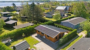 A residential area with multiple houses, a small dock, and a lake in the background. - 3 bedroom gorgeous home in Børkop (Børkop)