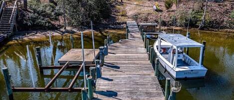 A wooden dock with a boat named "WATERLOO" docked at the end.