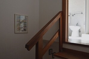 A staircase with wooden railings leading to a bathroom with a white sink and a handrail. - N286 - Numana, delightful sky-land house in the alleys (Numana)