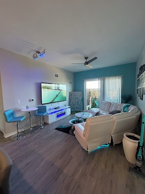 Relax in this cozy living space with a flat-screen TV, sofa, and coffee table.