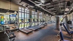 A gym with treadmills, weight machines, and exercise balls. - Relax in Style: Private Pool, Wave Surfing & More! (Kissimmee)