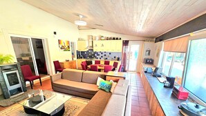 A living room with a sofa, chairs, a coffee table, and a fireplace. - ALGARVE ONE - Sports & Wellness Oasis, Volleyball, Billiards (Carvoeiro)