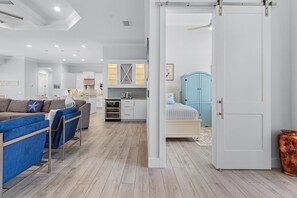 A modern interior with a kitchen, dining area, and bedroom. - Gulf Access, Heated Saltwater Pool, Kayaks - Villa Sunset Lagoon (Cape Coral)