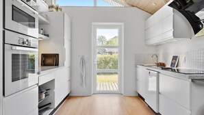 A modern kitchen with white cabinetry, a built-in oven, and a large window. - Pet friendly home in Farsø with WiFi (Farsø)