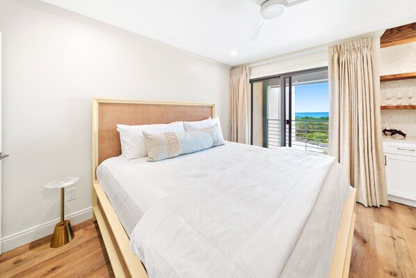 A bedroom with a large bed, a ceiling fan, a view of the ocean, and a balcony with curtains. - 30A Hideaway | 2 Bedroom | Gulf Views | Steps to the Beach | Inlet Beach (Inlet Beach)