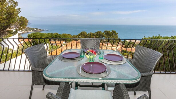A table set for two with a view of the sea. - Apartment Pardal by Interhome (Llançà)