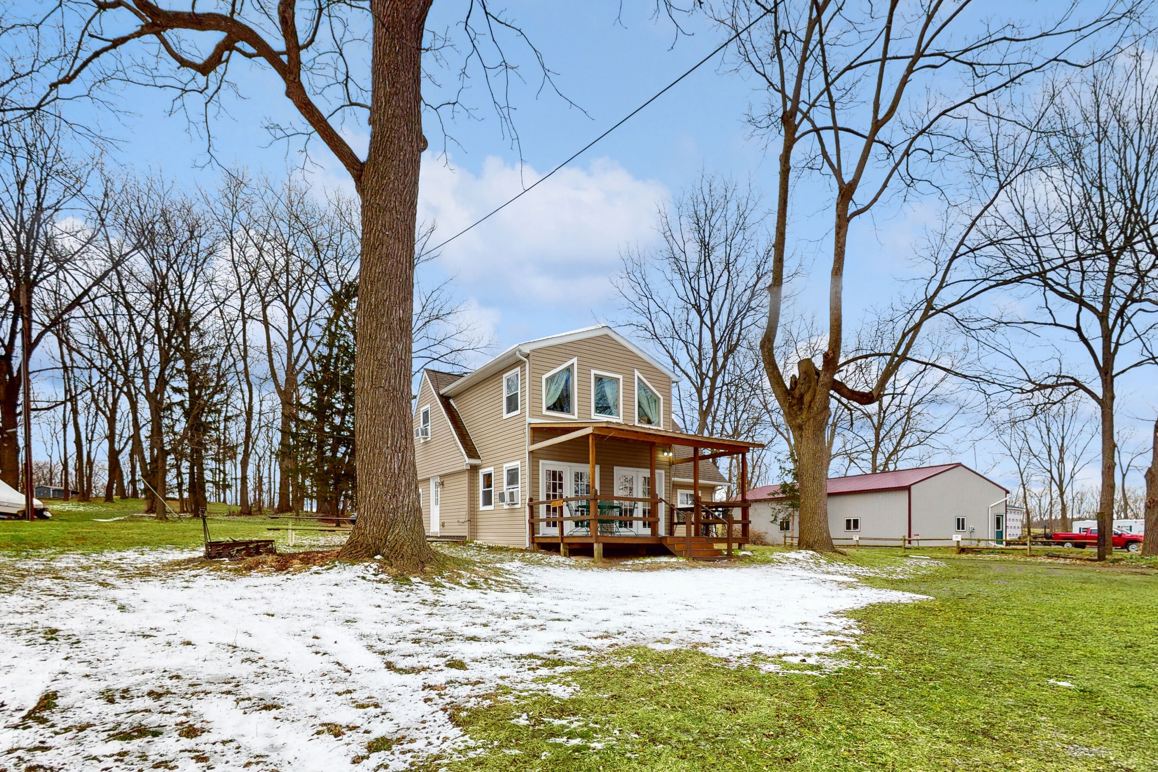 Lake-view retreat with dock access, firepits, & large yard