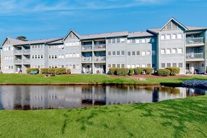 Stunning multi-story building with a central entrance and symmetrical facade, surrounded by a serene environment.