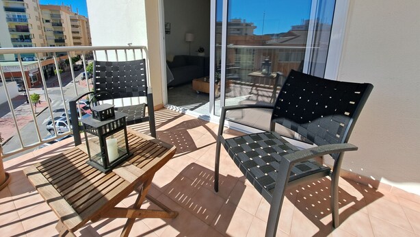 A balcony with two chairs, a small table, and a potted plant. - Ref: 324 Centric 3 bedroom apartment with swimming pool and close to everything (Fuengirola)