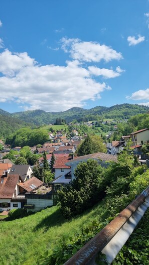 A rural village with houses, greenery, and a clear sky.