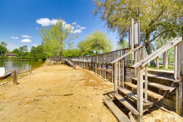 Stairs lead to a serene beach area with access to a higher vantage point.
