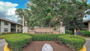 A sign with the name 'Shorewalk' surrounded by well-maintained hedges and a stone monument. - Bradenton Beach Condo -2 Pools- 15 minutes to Anna Maria Island Beaches-First Floor- End Unit (Bradenton)