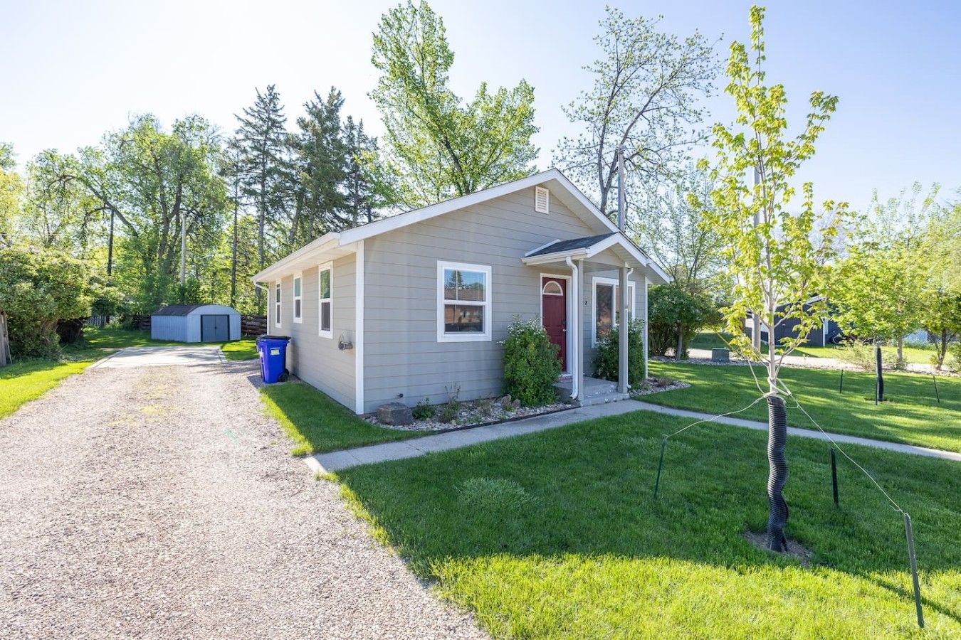 A single-story house with a front porch, a garage, and a well-maintained lawn.