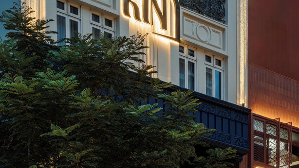 A building with a prominent illuminated sign reading "KIN". - Kin Hotel Dong Du (Ho Chi Minh City)