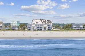 A beachfront hotel with multiple floors, balconies, and a sandy beach in the foreground. - *Fall into Savings-20% Off New Bookings thru 2026* (Murrells Inlet)