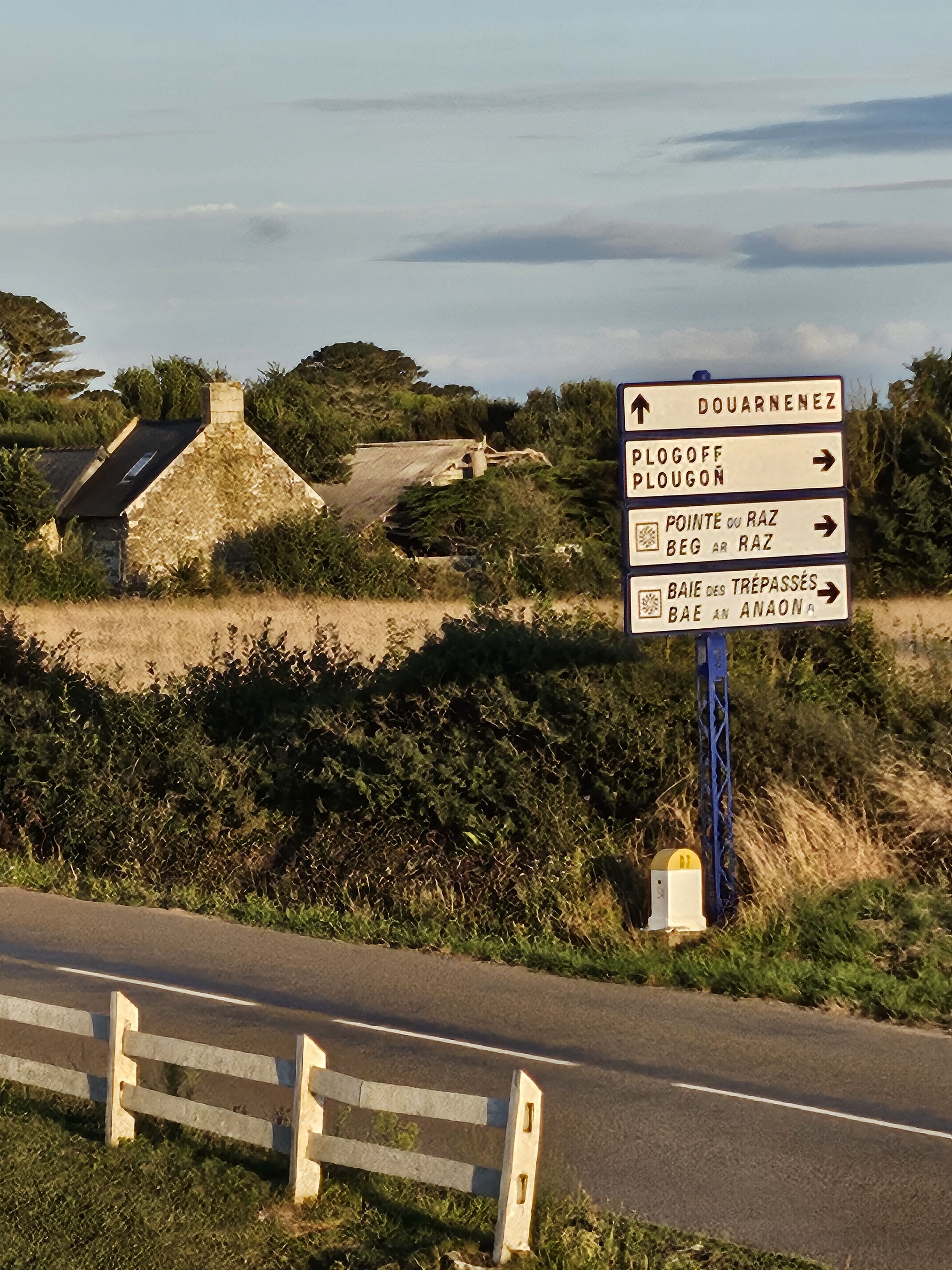 A directional signpost with multiple arrows pointing towards various destinations.
