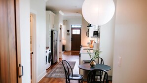 A modern kitchen with white cabinets, a stainless steel refrigerator, and a coffee machine. - Chic 2BR Cabin D by MHM Luxury Properties (Jasper)