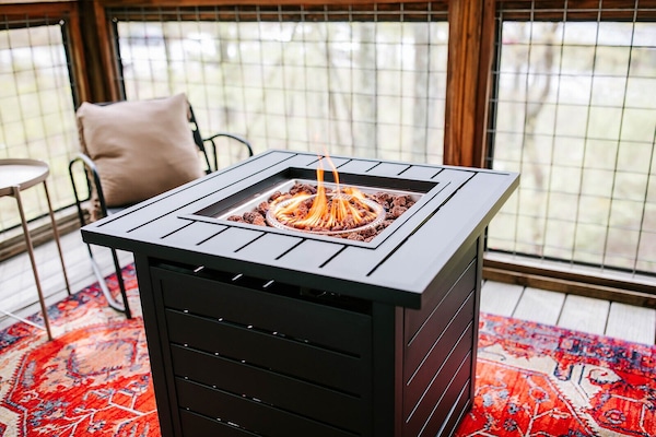 Stay warm and cozy! Our cabin boasts a propane fire table, perfect for gathering around and enjoying the evening outdoors.