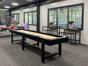 Enjoy a game of pool in our spacious room with a long, rectangular pool table and comfortable seating.