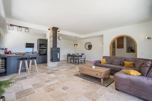 A modern living space with a kitchen, dining area, and seating area.