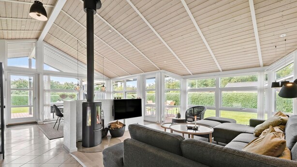 A spacious living area with a large fireplace, comfortable seating, and a television.