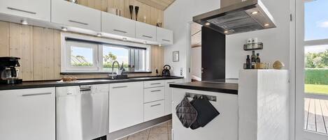 Fridge, stovetop, dishwasher, coffee/tea maker