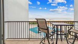 A balcony with a view of a pool and the ocean. - Includes Xplorie Activities and Linens. PYRAMID - 2BR oceanfront condo w/outdoor pool. (Ocean City)