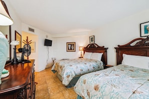 A hotel room with two beds, a desk, a chair, a television, and a window. - Includes Xplorie Activities and Linens. PYRAMID - 2BR oceanfront condo w/outdoor pool. (Ocean City)
