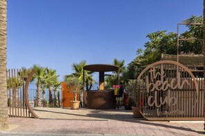 A gated entrance with a sign reading 'The Beach Club.' - Luxury Apartment with Garden in Higueron (Fuengirola)