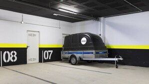 A parking garage with a trailer marked 'ARTISHOW' and numbered 07. - Luxury Apartment with Garden in Higueron (Fuengirola)