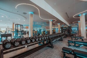 A modern gym with weightlifting equipment, exercise machines, and a variety of fitness accessories. - Luxury Apartment with Garden in Higueron (Fuengirola)