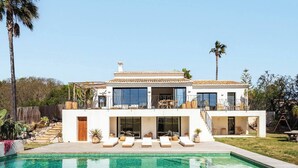 A modern two-story house with a swimming pool, large windows, and outdoor seating. - Villa Jade (La Mandarina)