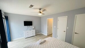 A bedroom with a bed, a dresser, a ceiling fan, and a TV. - Sunny Getaway * 1BR condo close to the beach (A) (Myrtle Beach)