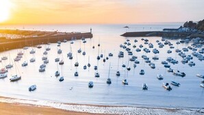 A marina filled with boats during sunset.