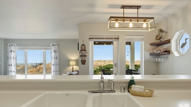 A bathroom with a large white bathtub, a modern faucet, and a hanging light fixture. - 113 - A Breath of Fresh Air, Dogs welcome! (Westport)