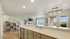 A modern kitchen with a large island, built-in appliances, and a view of the outdoors. - 113 - A Breath of Fresh Air, Dogs welcome! (Westport)