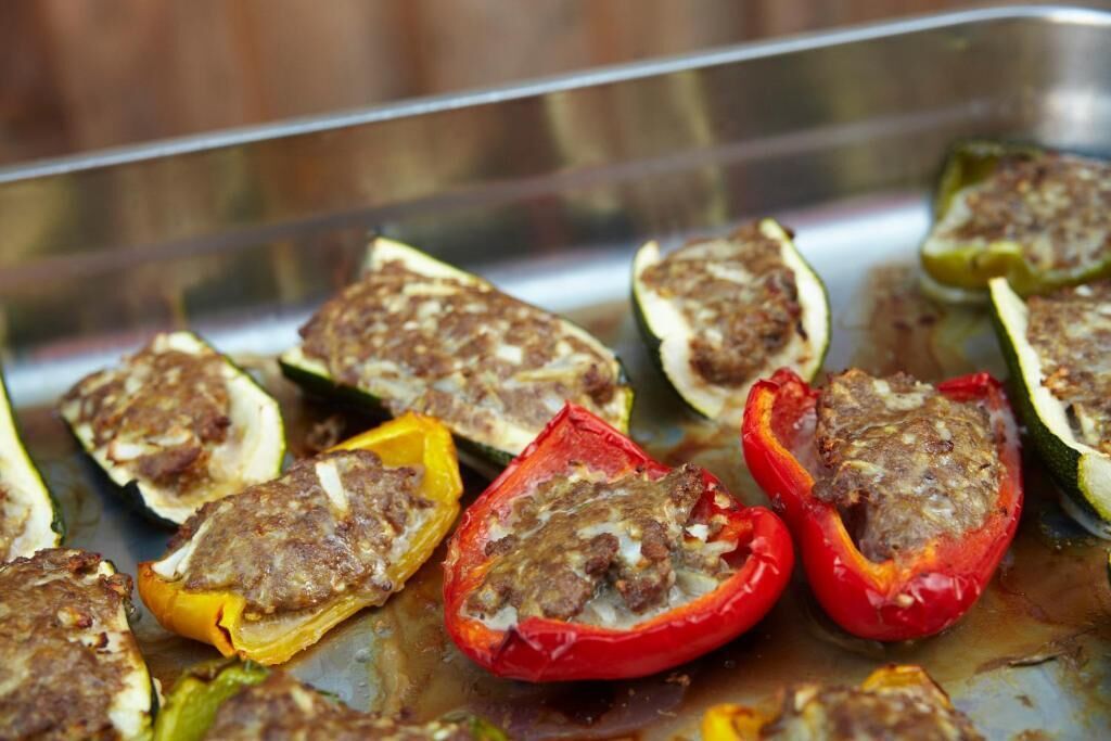 Stuffed bell peppers on a baking tray.