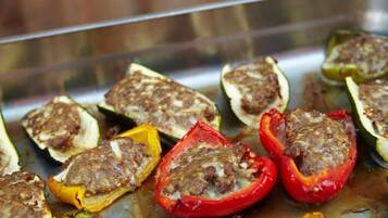 Stuffed bell peppers on a baking tray.