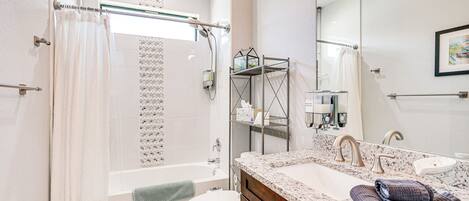 A modern bathroom with a bathtub, toilet, and sink.