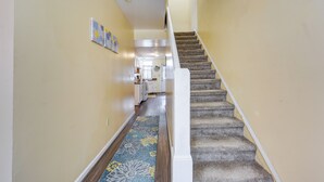 A carpeted staircase with a white handrail leading to a landing. - Cozy East Pittsburgh Home - 7 Mi to Frick Park! (East Pittsburgh)