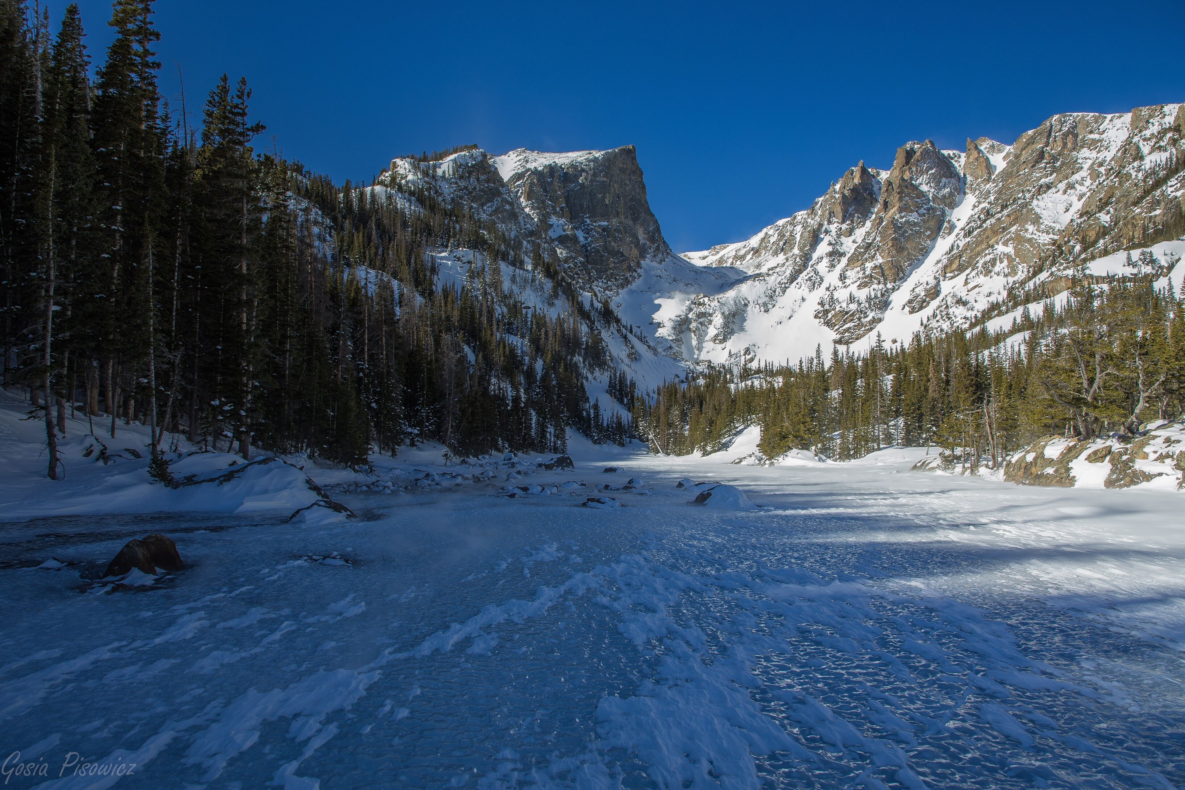A snowy mountain landscape with a clear sky.