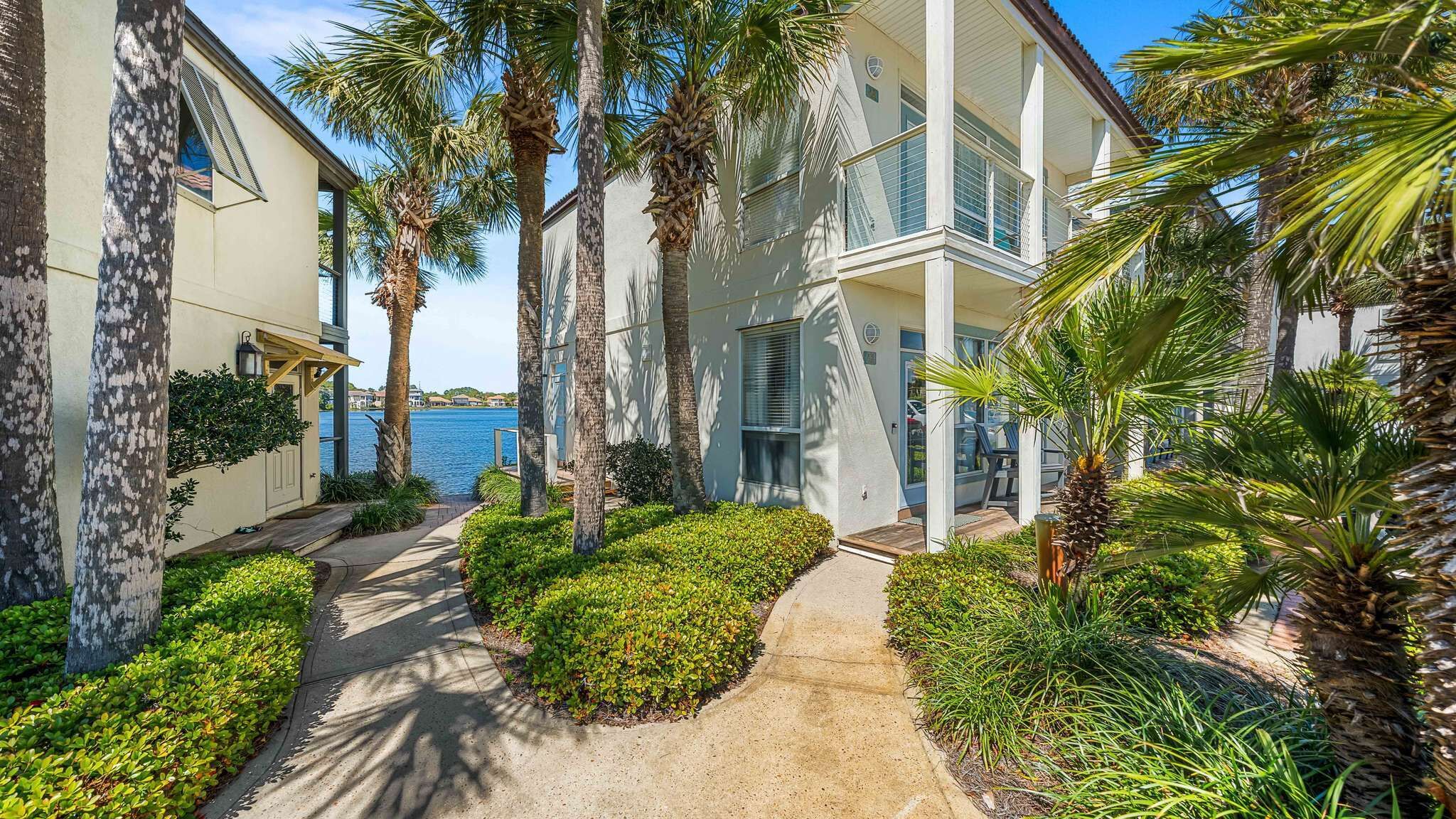 A coastal building with a pathway leading to a balcony overlooking the sea.