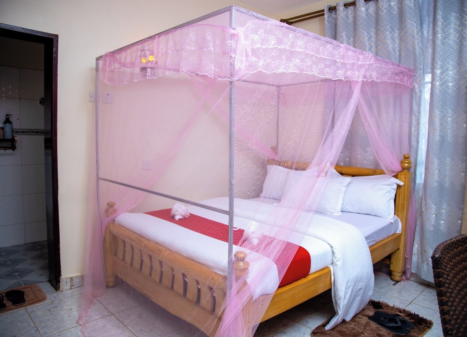 A single bed with a wooden frame and a canopy.