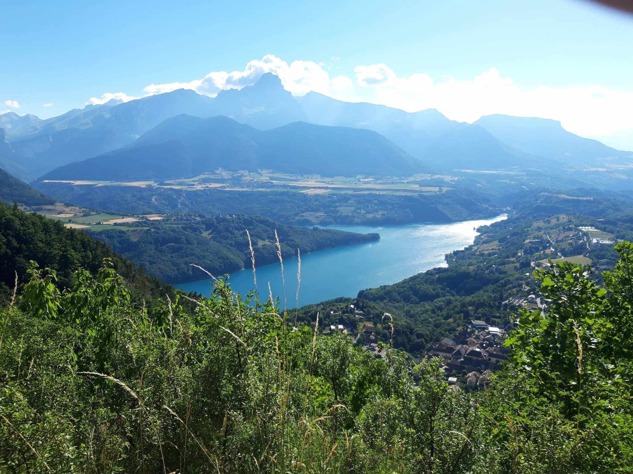 A mountainous landscape with a lake and a village.