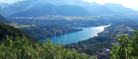 A mountainous landscape with a lake and a village.