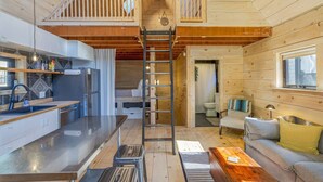 A compact cabin with a kitchen, dining area, and a small living space. - Walkable Studio in Downtown Bar Harbor [Sea Smoke] (Bar Harbor)