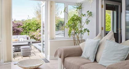 A spacious holiday home with a heavenly hot tub close to stunning beaches.