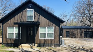 A rustic wooden building with a sign reading "The Coyote Den's The Loft". - Loft near Bennett Springs State Park (Lebanon)