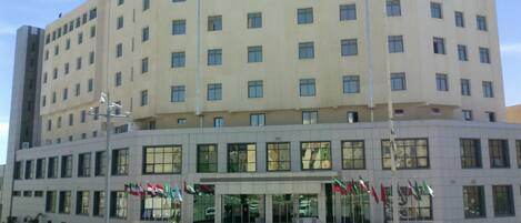 A multi-story building with a symmetrical facade, large windows, and a central entrance.